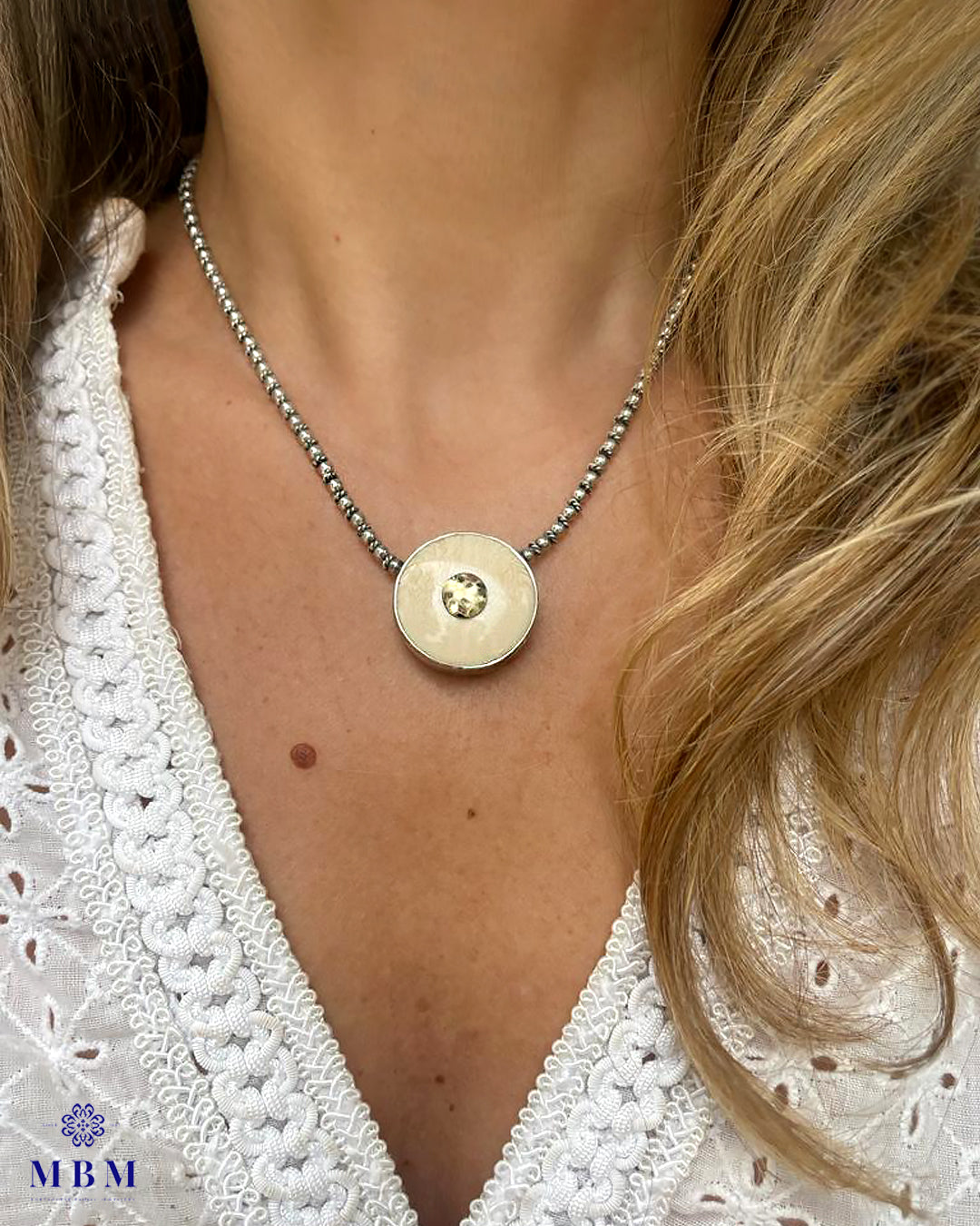 Silver and gold necklace with vegetable ivory medal