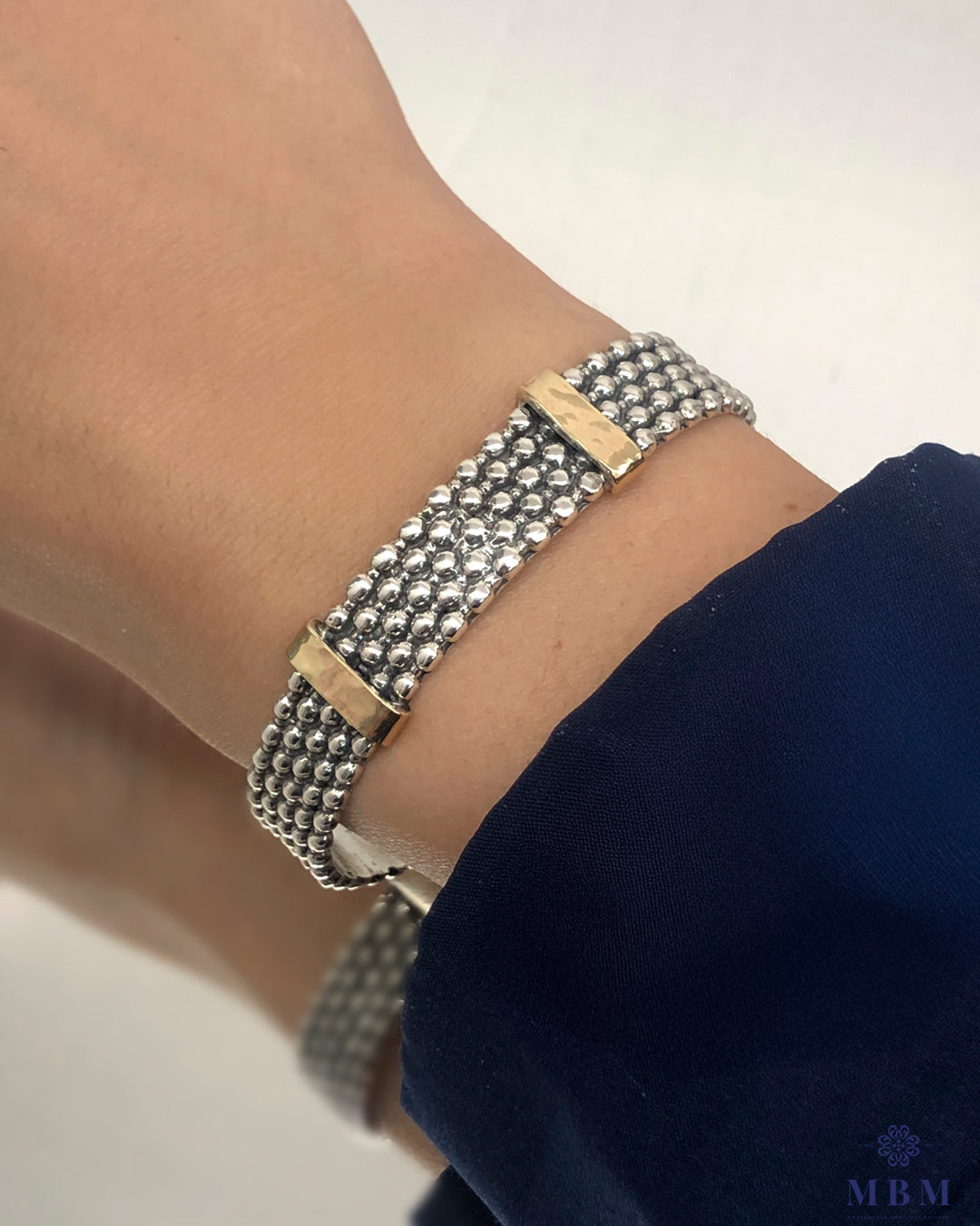 Pulseira em prata e dois travessões em ouro